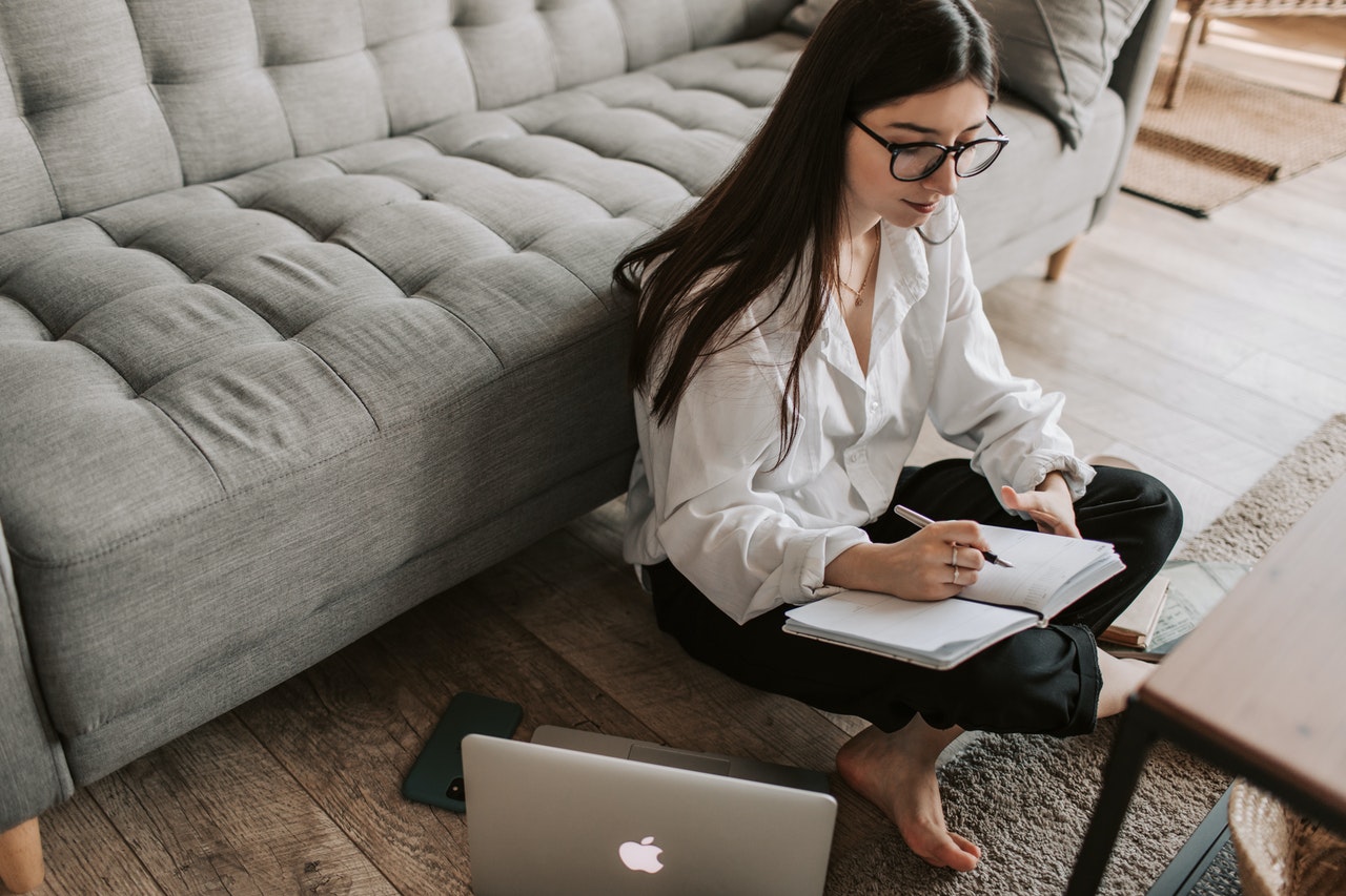 https://www.pexels.com/photo/woman-writing-on-notebook-4050301/